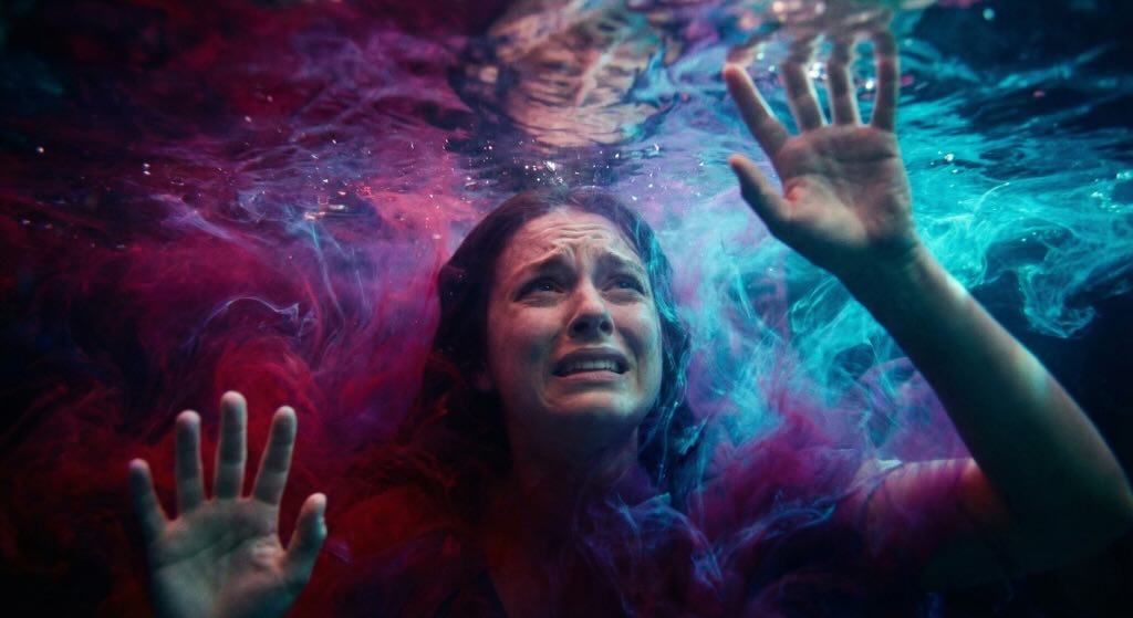 Pessoa submersa em águas coloridas demonstrando ansiedade, ilustrando a instabilidade de um dos tipos de amor mais intensos, o Eros.
